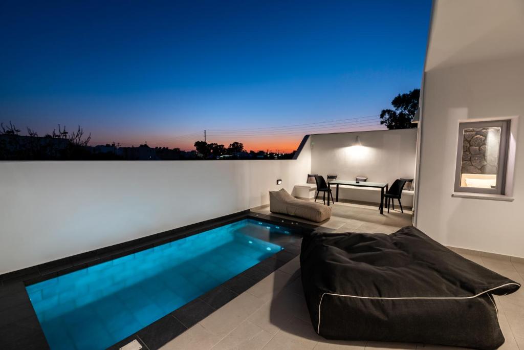 a living room with a swimming pool in a house at Filoxenia Luxury Villas in Perissa