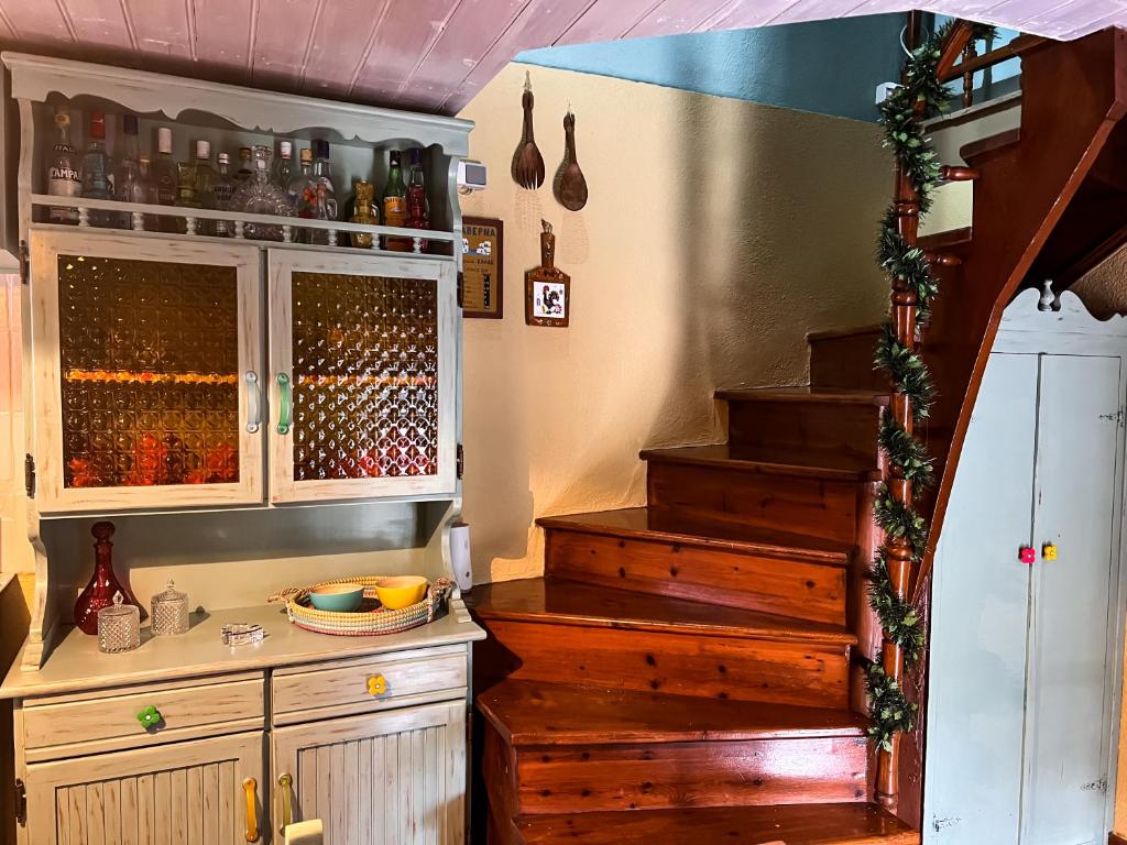 a kitchen with a staircase and a cabinet with wine bottles at DandyVillas-Vintage Cottage House-Pelion-Argalasti-Kallithea in KallithÃ©a
