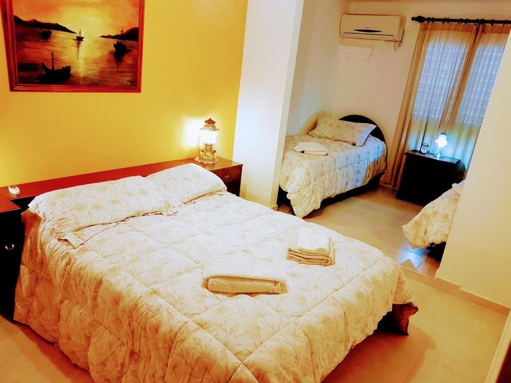 a bedroom with two beds with towels on them at Cabañas Cerros Azules en La Rioja Alojamiento Temporario in La Rioja
