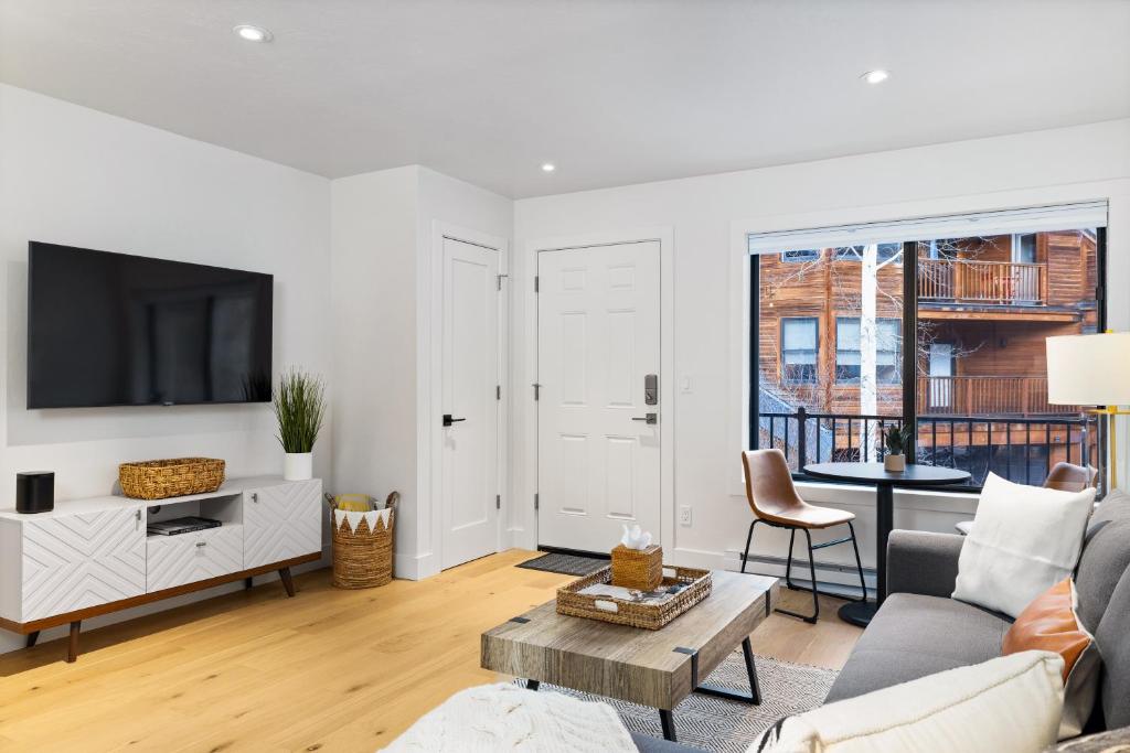 a living room with a couch and a tv at Boomerang 203 - A Telluride Retreat in Telluride