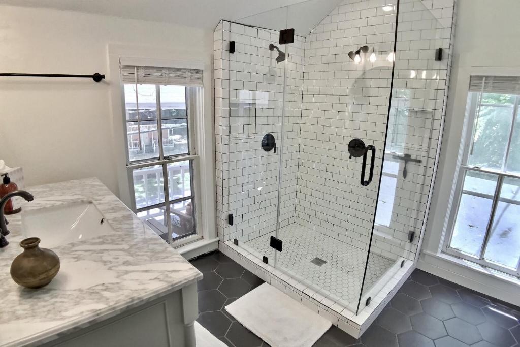 a bathroom with a shower and a sink at The Pink House on Main - Upper in Eureka Springs