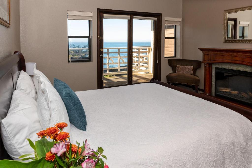 a bedroom with a bed with a view of the ocean at Wharf Master's Inn in Point Arena
