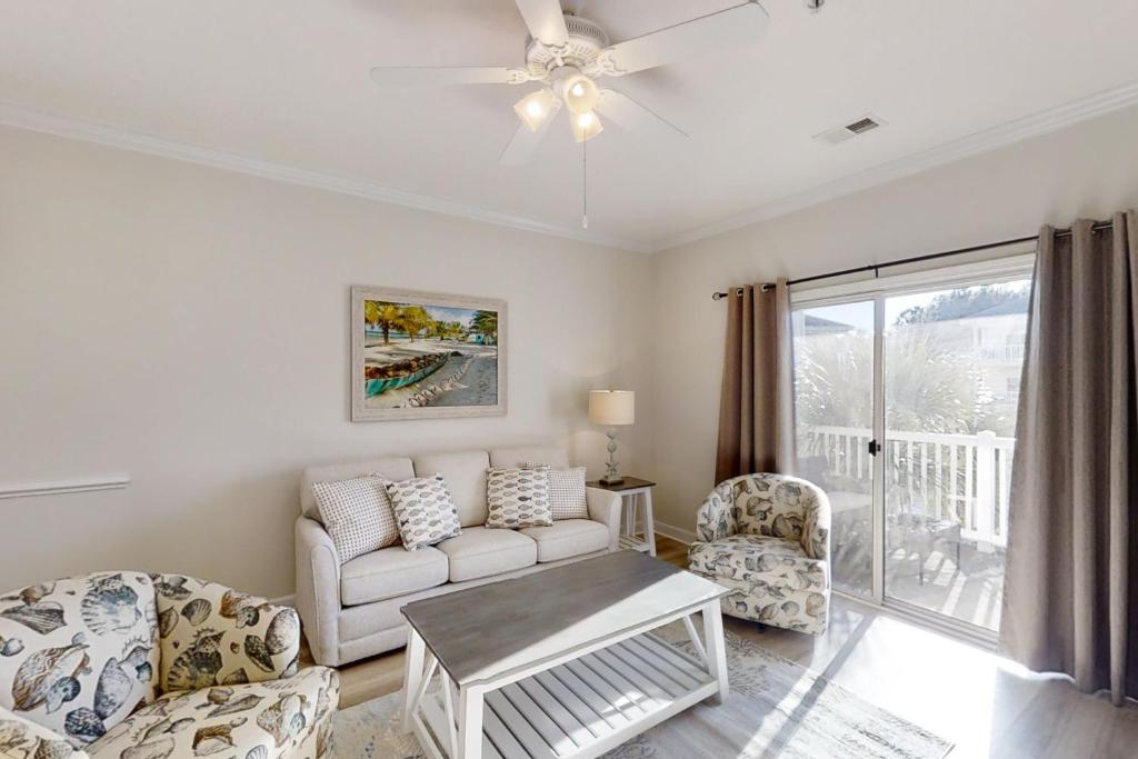 a living room with a couch and two chairs at Costa Del Ray in North Myrtle Beach