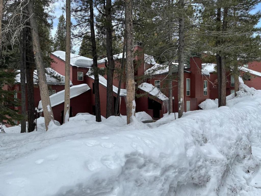 a pile of snow in front of a red house at Golf Club Condos #437 in Truckee