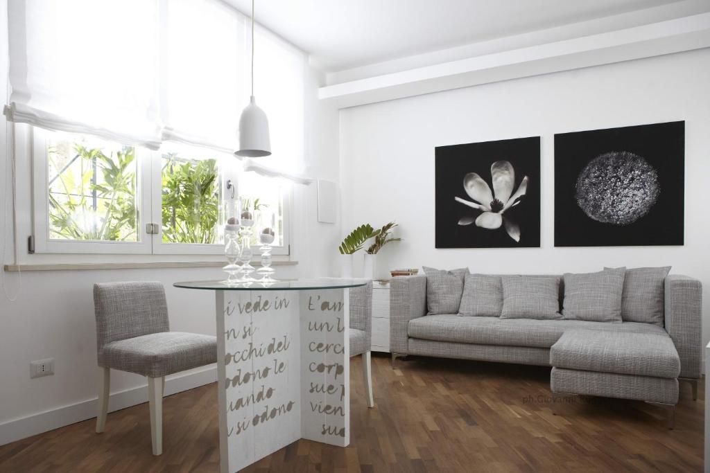 a living room with a couch and a table at Ferrini Home - Piazza Trento in Catania