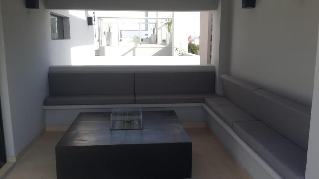 a room with a coffee table in front of a window at Hermoso departamento boutique con pileta in Salta