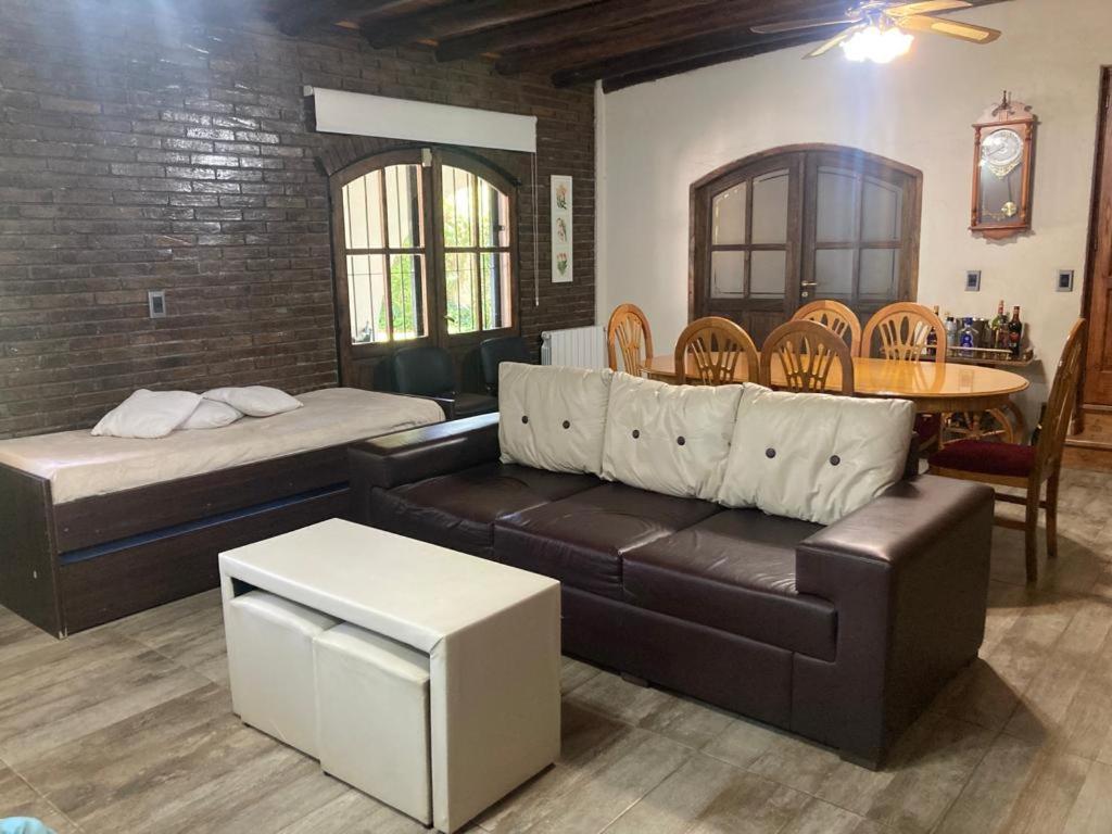 a living room with a couch and a bed at NUESTRA CASA EN CHACRAS DE CORIA (Bª PRIVADO) in Chacras de Coria