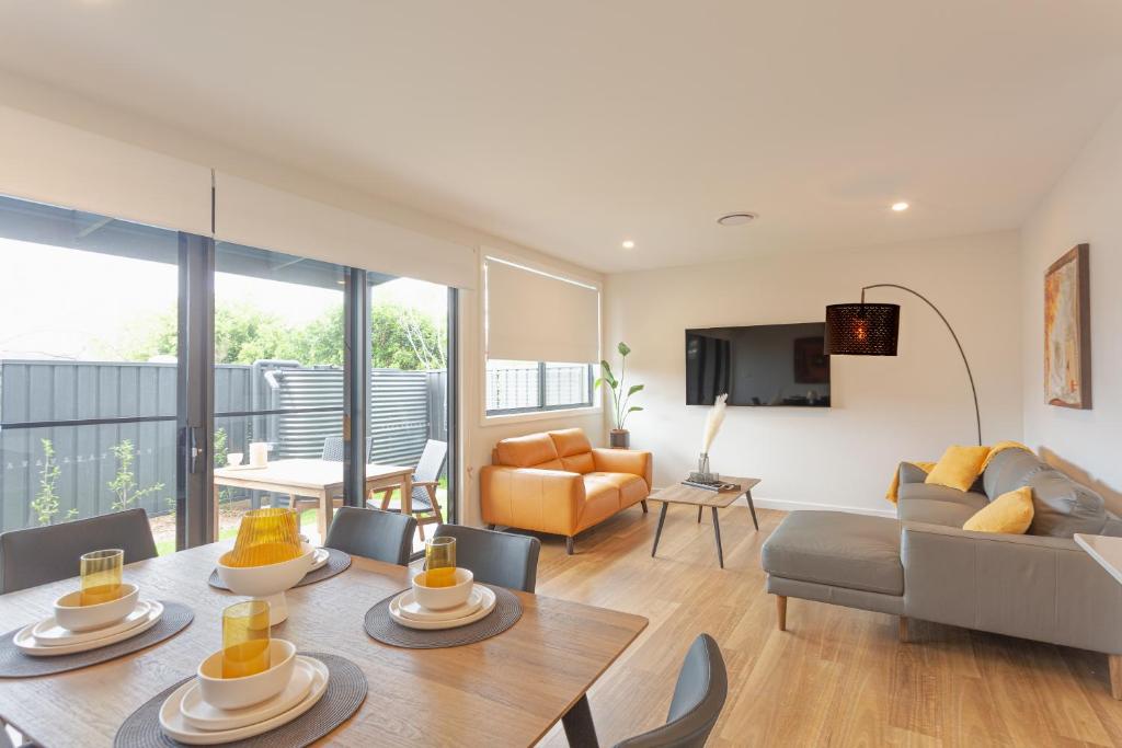 a living room with a table and a couch at Chapel Heights Apartments in New Lambton