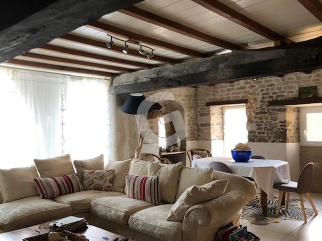 a living room with a couch and a table at Maison Le Bernard, 5 pièces, 6 personnes - FR-1-357-253 in Le Bernard