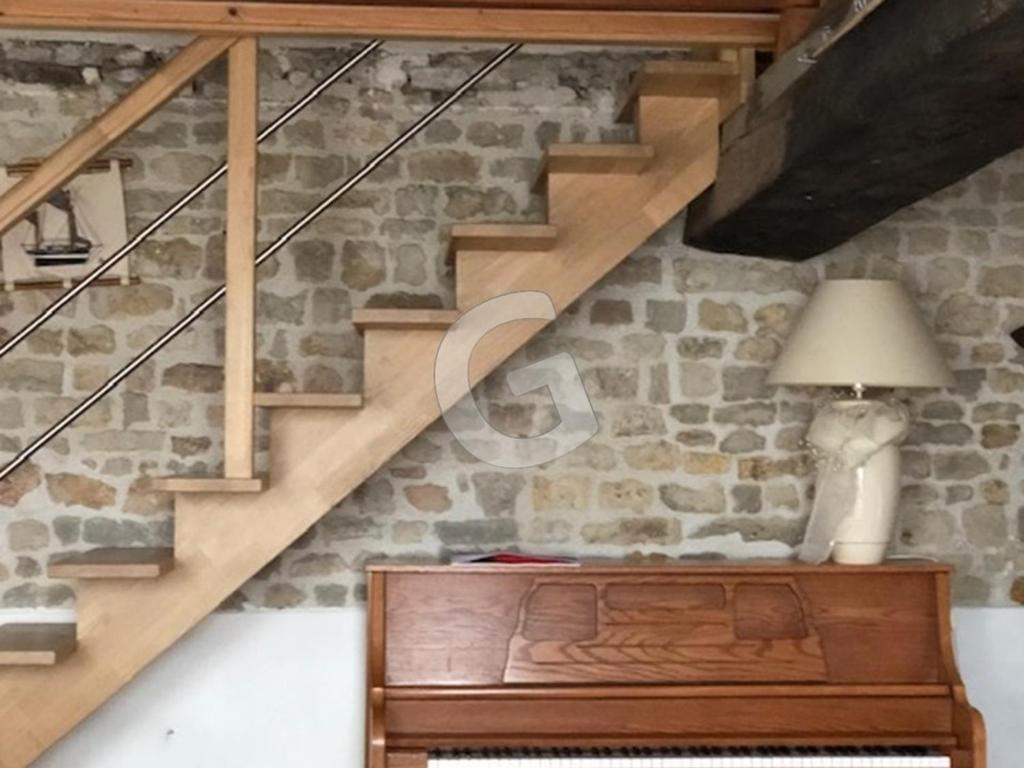 a room with a staircase with a lamp and a table at Maison Le Bernard, 5 pièces, 6 personnes - FR-1-357-253 in Le Bernard