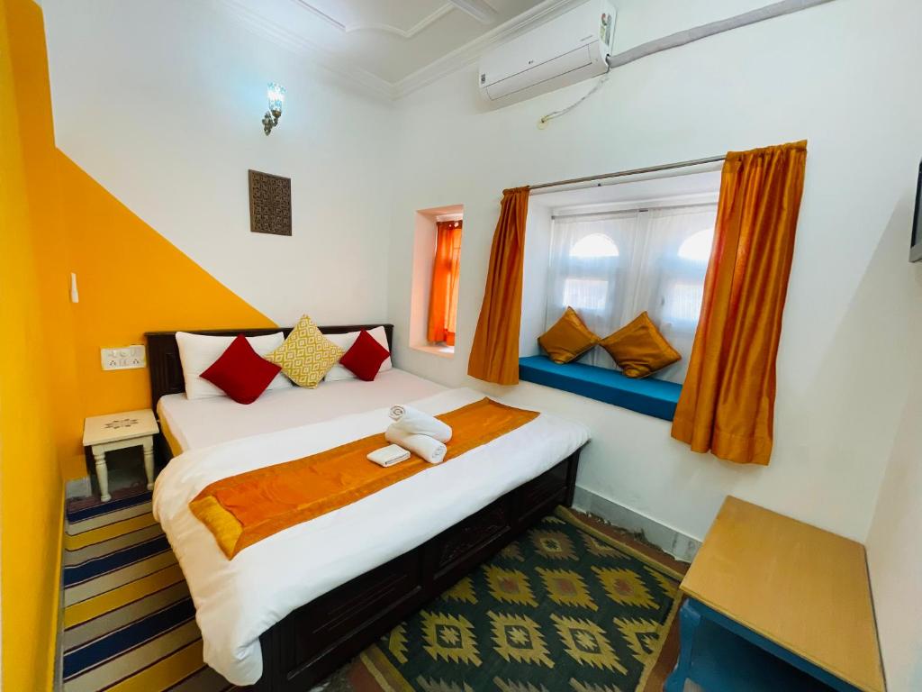 a bedroom with a bed with a teddy bear on it at Jaisalmer Hostel Crowd in Jaisalmer