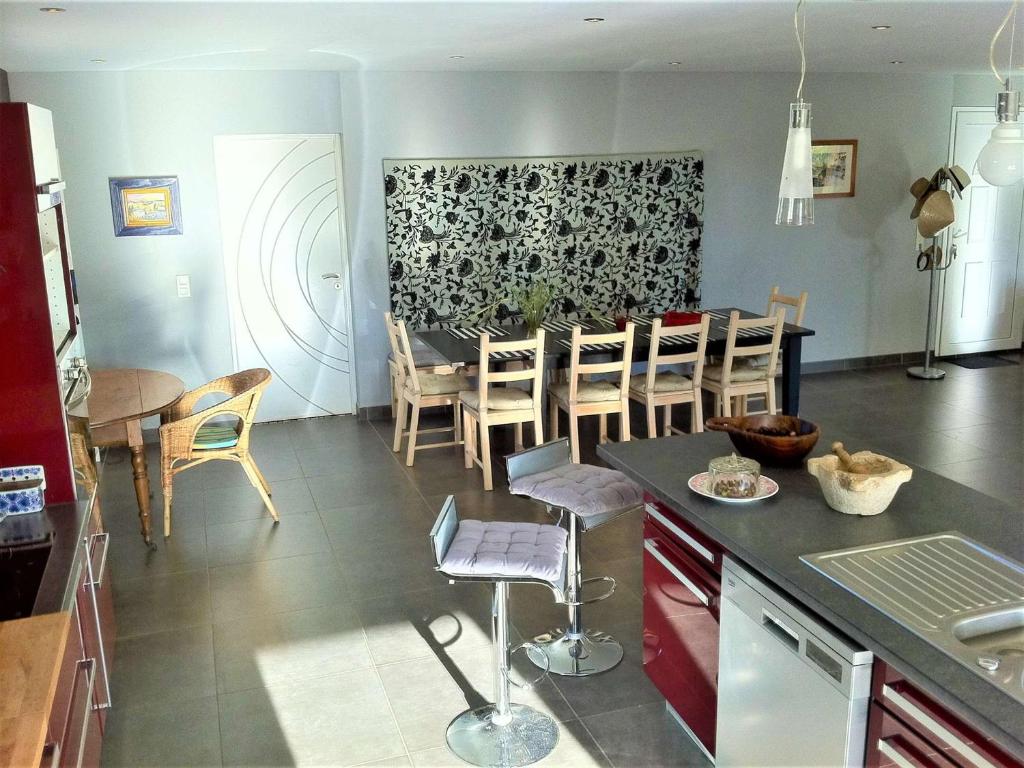 a kitchen and dining room with a table and chairs at Maison Vagnas, 4 pièces, 6 personnes - FR-1-382-176 in Vagnas