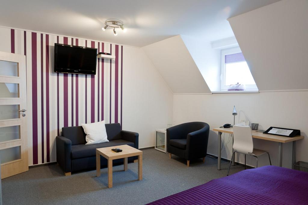 TV a/nebo společenská místnost v ubytování Hotel Berger
