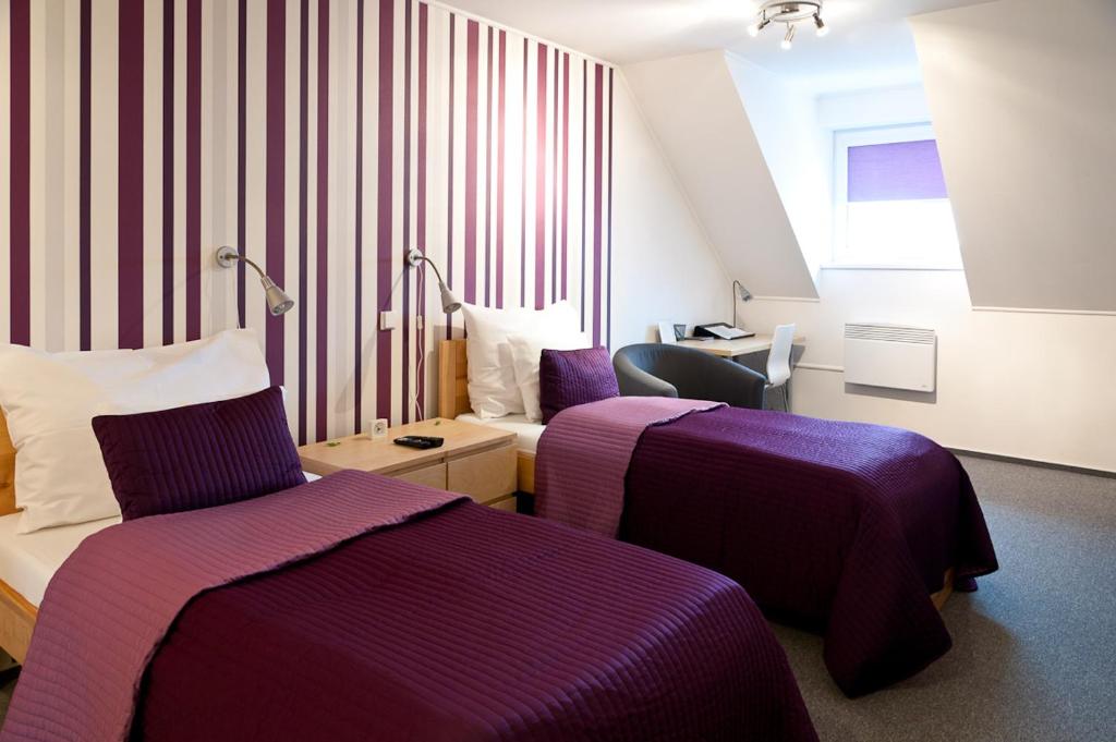 Postel nebo postele na pokoji v ubytování Hotel Berger