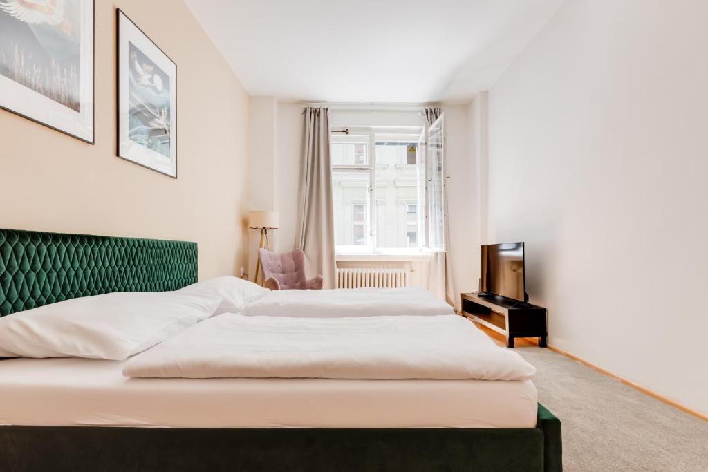 Łóżko lub łóżka w pokoju w obiekcie Riben House Prague