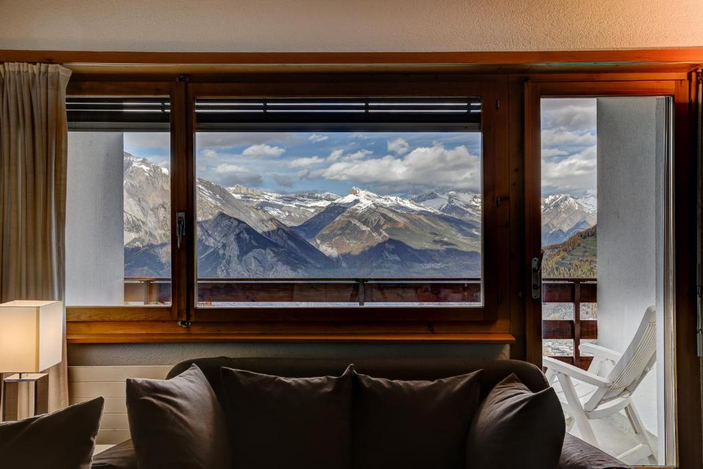 a window with a view of snow capped mountains at Appartement Mont Parrain 14 in La Tzoumaz