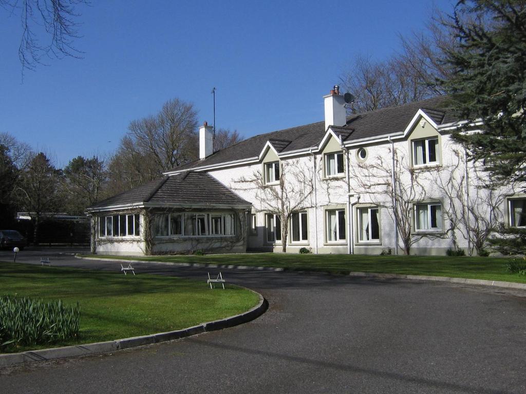 a white house with a black roof at Sea Dew B&B in Tullamore