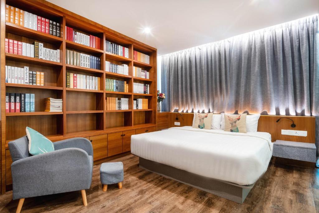 Un dormitorio con una cama y una estantería. en Apple Hotel Times Square, en George Town