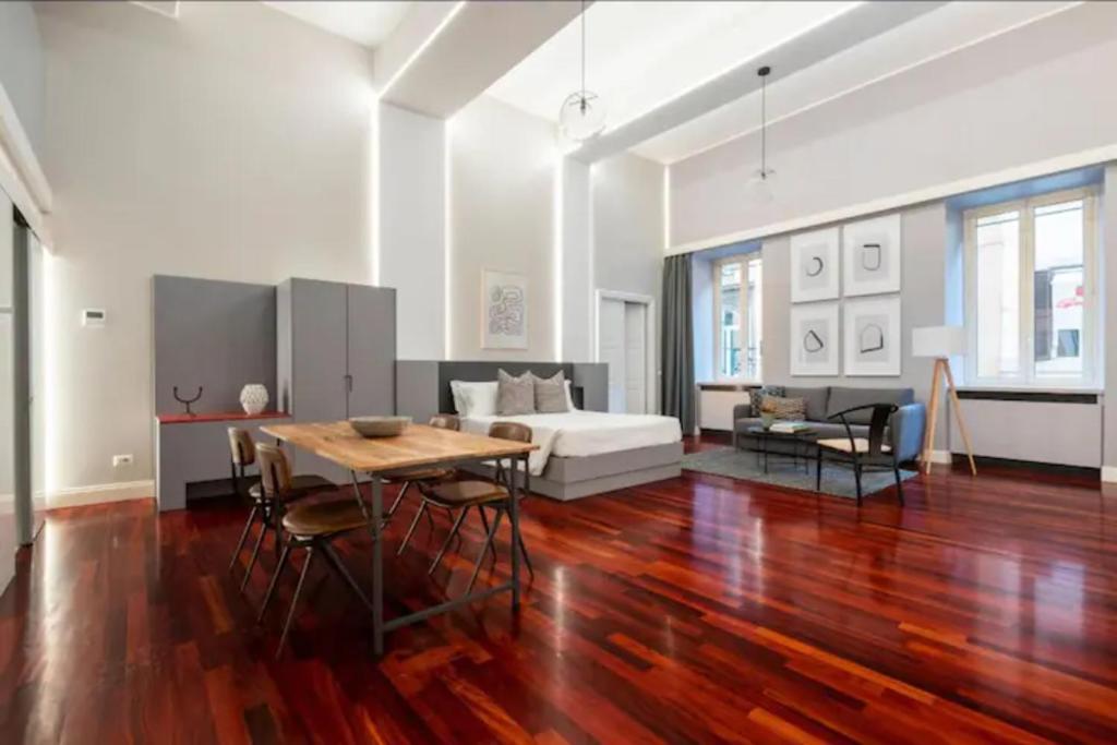 a living room with a bed and a table and chairs at Croce Apartments in Rome