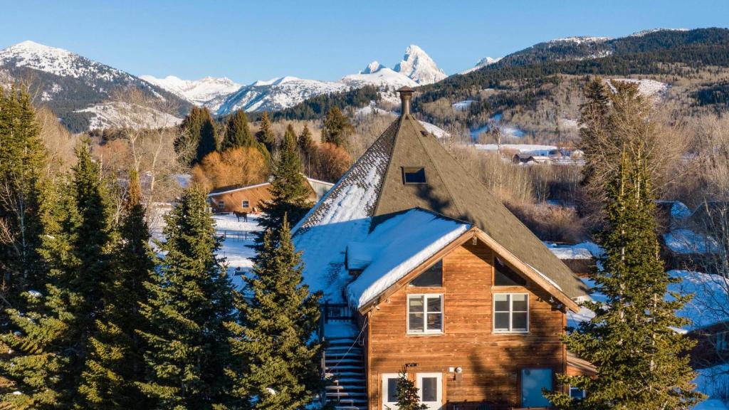 a log cabin in the mountains with snow at Teton Teepee Lodge in Alta