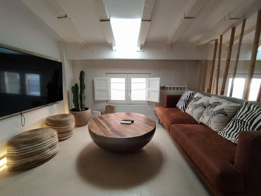 a living room with a couch and a coffee table at Charming loft in the heart of El Carmen Valencia in Valencia