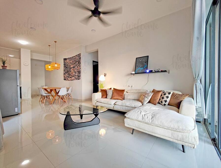 a living room with two couches and a ceiling fan at Amberside, Country Garden Danga Bay Homestay by WELCOME HOME in Johor Bahru