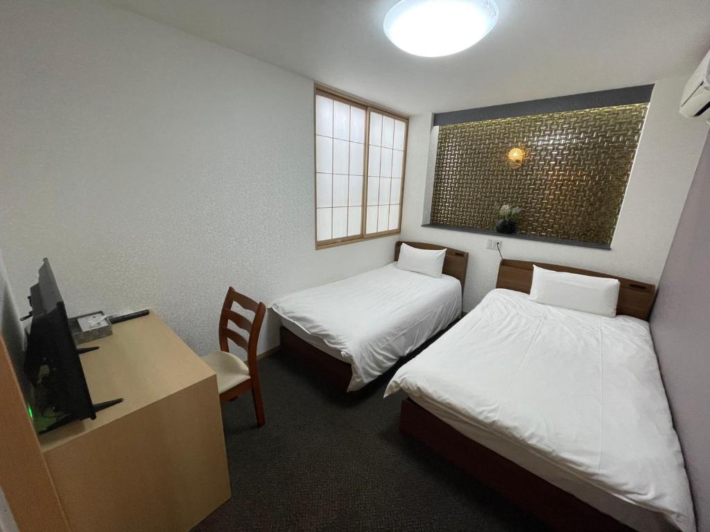 Postel nebo postele na pokoji v ubytování Allcomein Hotel Akihabara