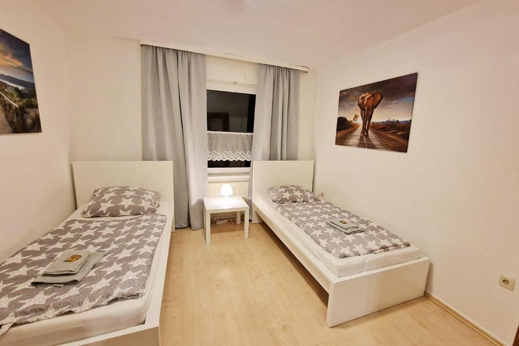 a room with two beds and a window at Nice Apartments in Gummersbach in Gummersbach