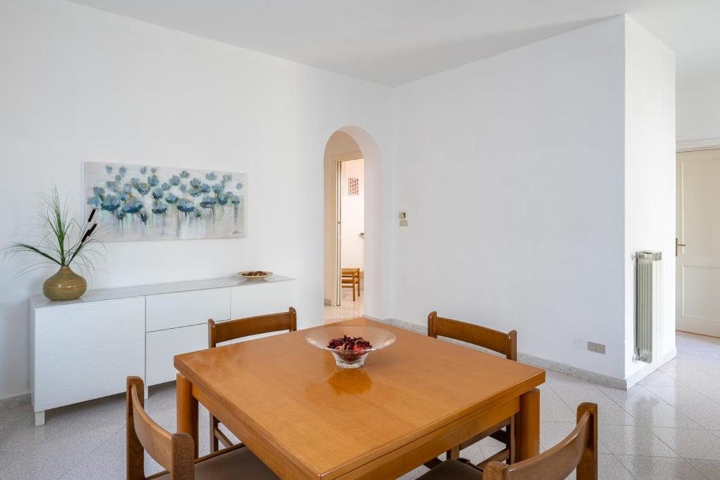 a dining room with a wooden table and chairs at Vallevo 42 in San Vito Chietino