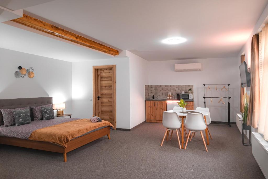 1 dormitorio con 1 cama, mesa y sillas en The Dom 21, en Cluj-Napoca