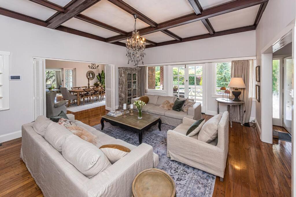 a living room with two couches and a table at Kerrisdale Bowral in Bowral