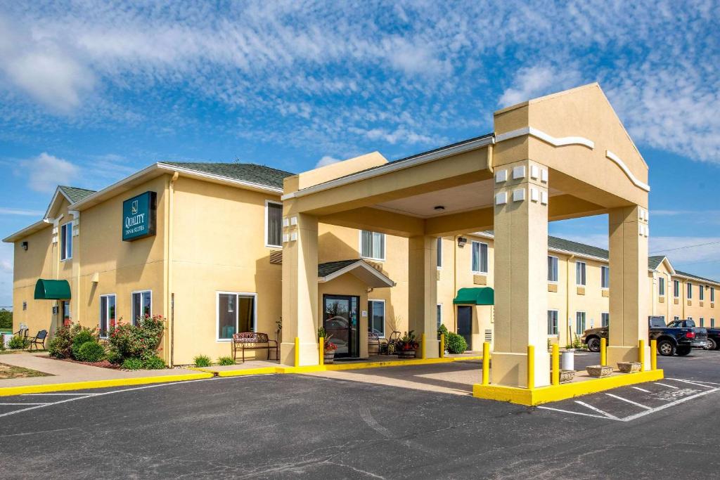 a large hotel building with a parking lot at Quality Inn & Suites in Brandenburg