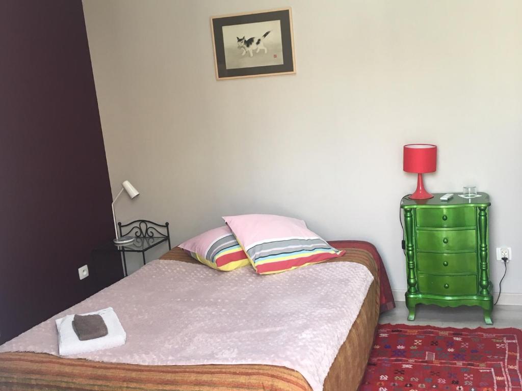 a small bedroom with a bed and a green dresser at Chambre calme indépendante avec Salle de bains -Petit déjeuner-Grande Terrasse- Proche du centre in Bordeaux