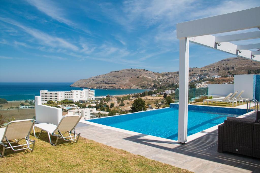 a villa with a pool and a view at Blue Horizon 2 in Líndos