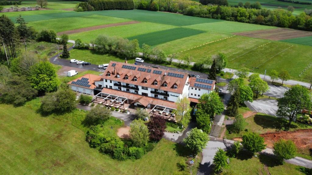 an aerial view of a large building in a field at Seehotel Losheim in Losheim