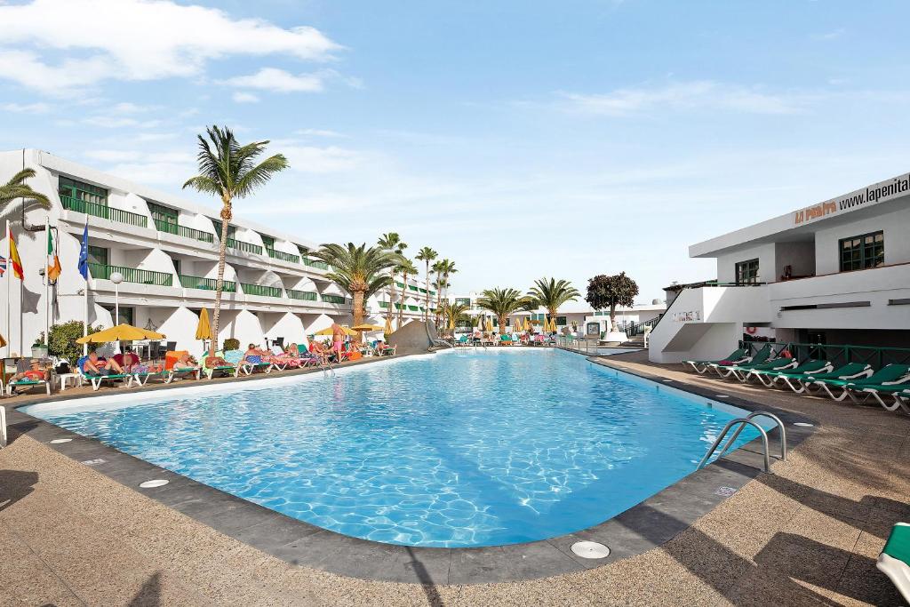 a large swimming pool in front of a hotel at Casa Joyne in Puerto del Carmen