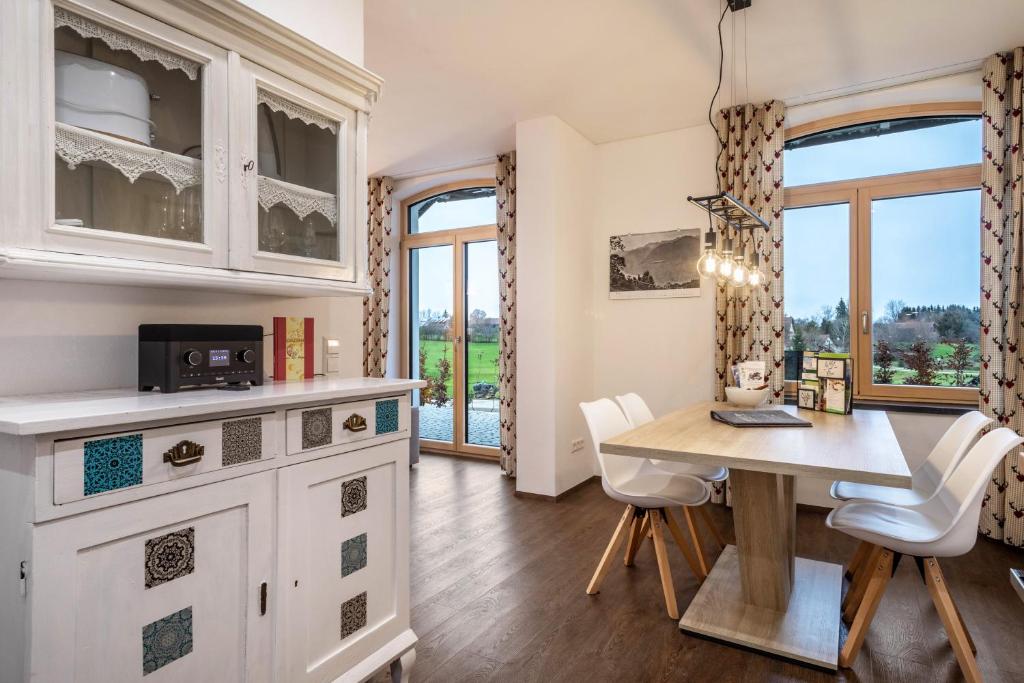 a kitchen with a table and chairs and a dining room at Butterei in Argenbühl