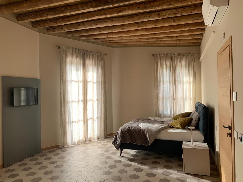 Postel nebo postele na pokoji v ubytování Palazzo Fritz