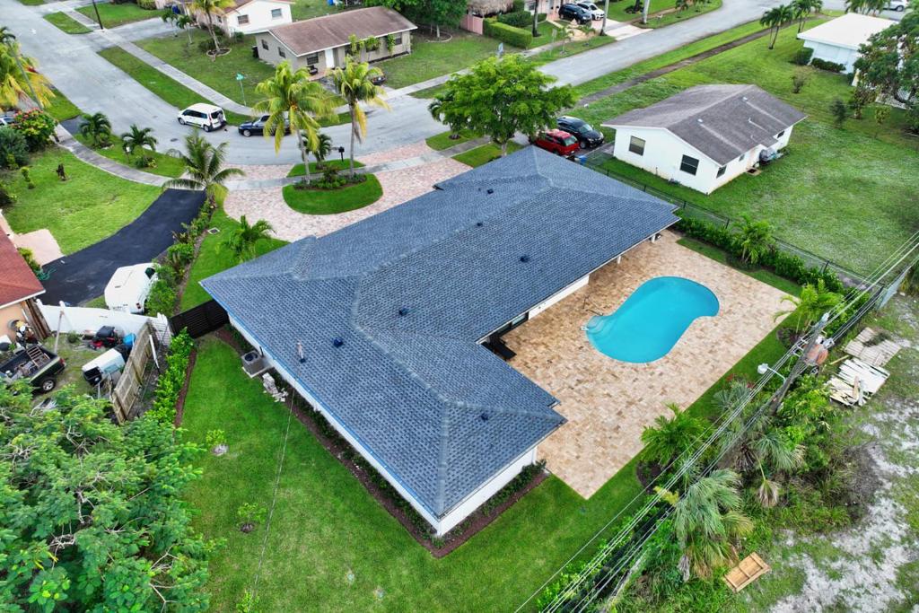 an aerial view of a house with a blue roof at Sandals Beach Cottage in Fort Lauderdale