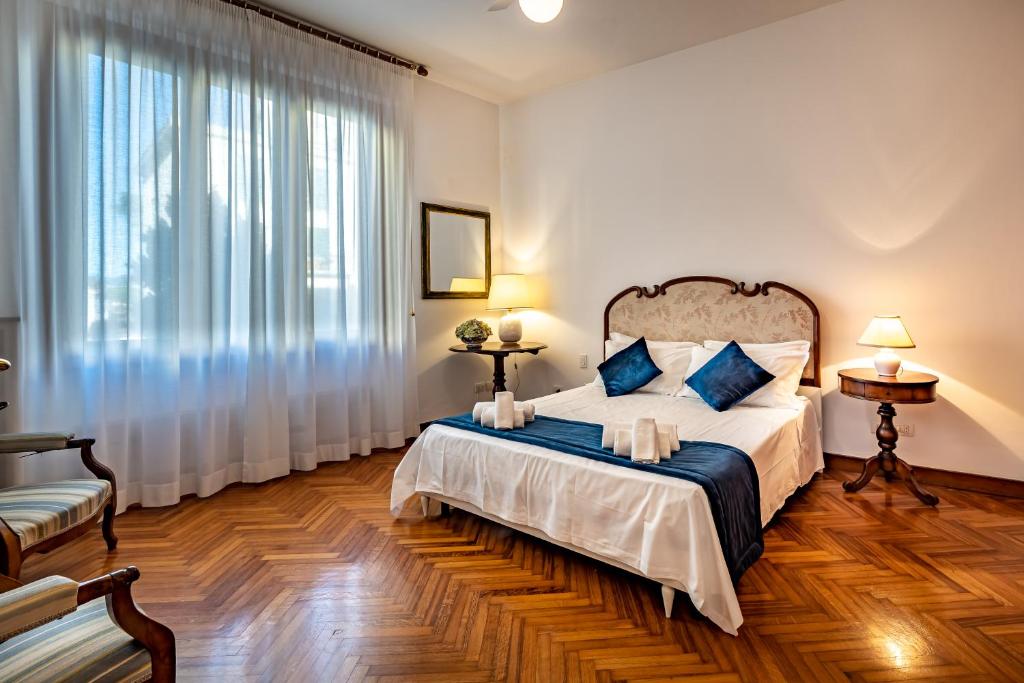 a bedroom with a bed and a large window at YiD Leopolda apt few minutes from Central Station in Florence