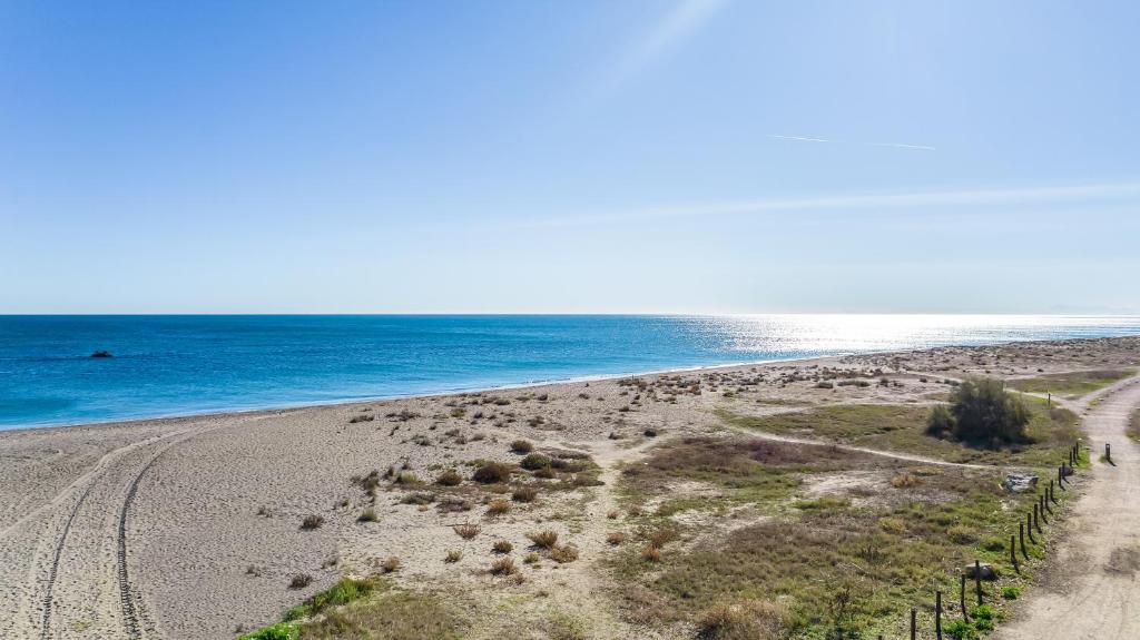 an empty beach with the ocean in the background at Don Juan Beach Resort in Estepona