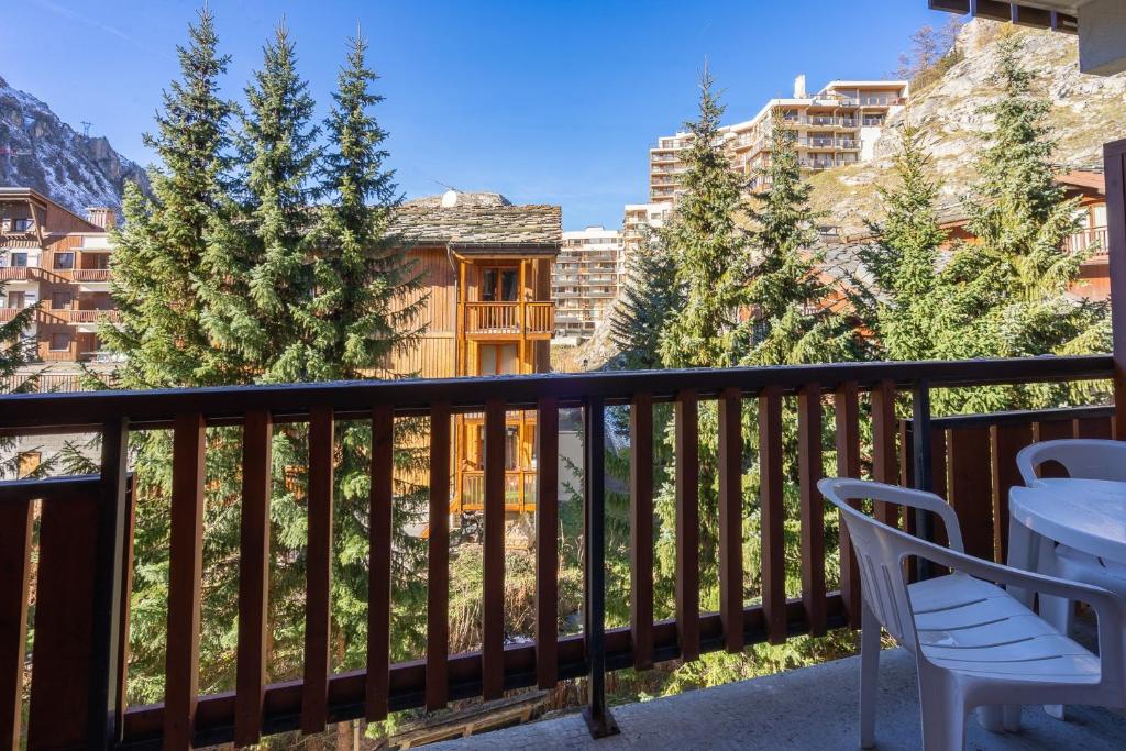 a balcony with a table and chairs and trees at Solaise in Val-d'Isère