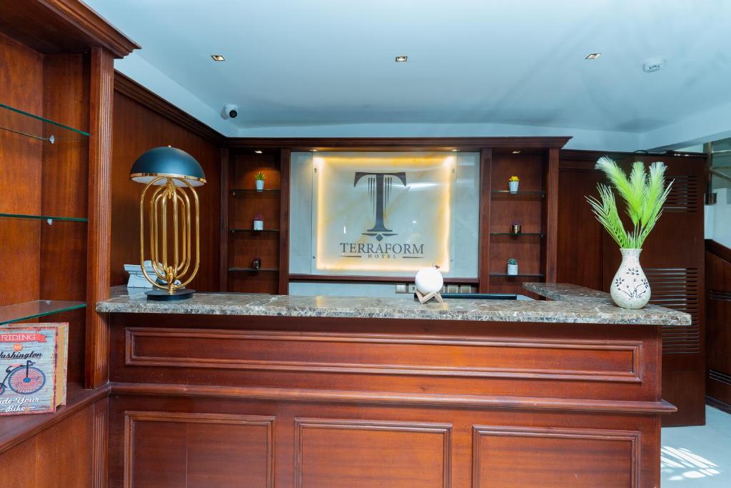 a bar in a room with wood paneling at Terraform Hotel in Lagos