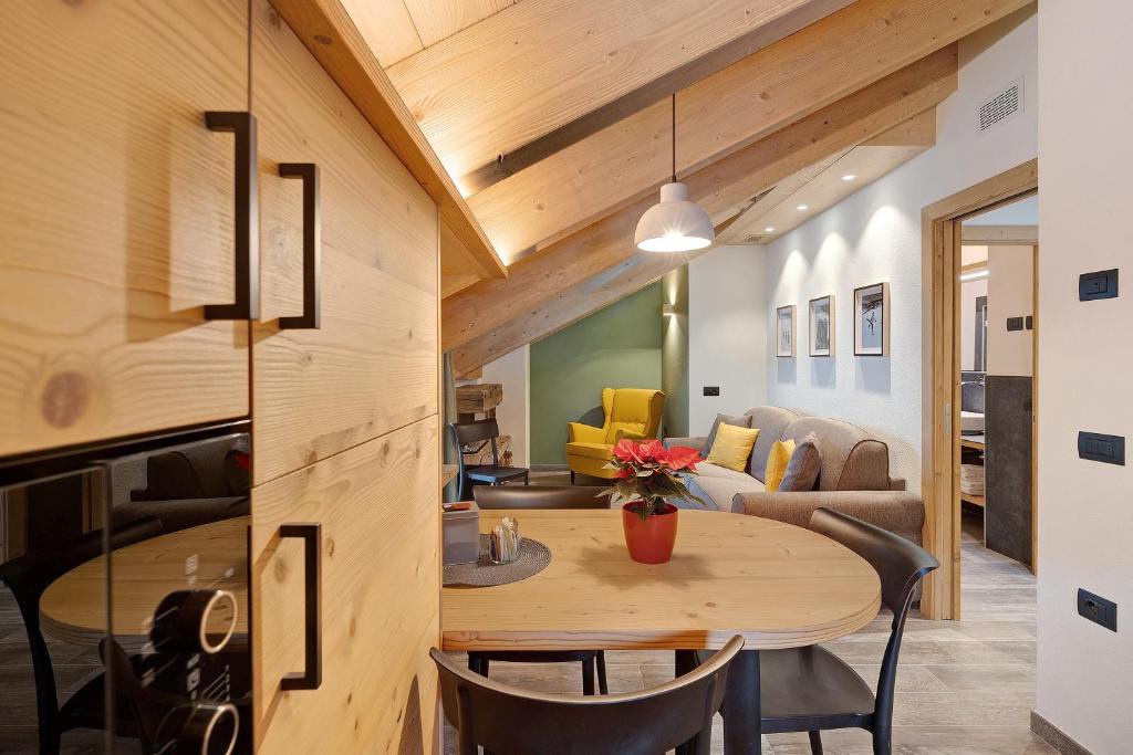 a dining room and living room with a table and chairs at Gemma Rosina's Home in Livigno