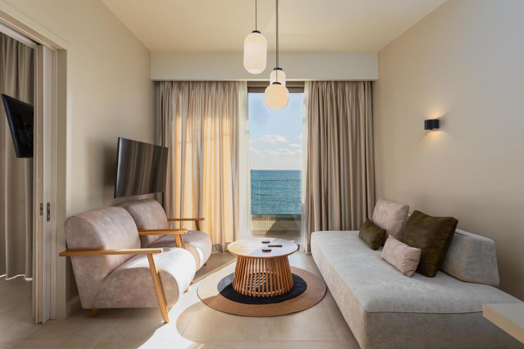 a living room with a couch and a table at KALES SEA VIEW SUITES in Ierápetra