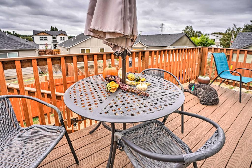 a table with an umbrella on a deck at Springfield Apt with Deck and Central Location! in Springfield