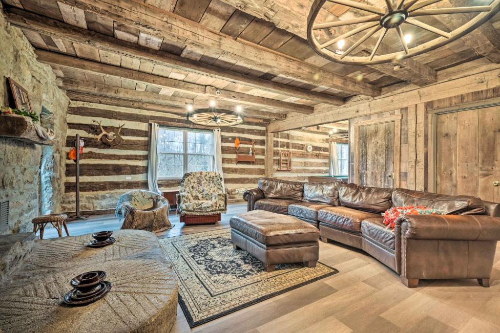 uma sala de estar com um sofá de couro e uma mesa em New Paris Cabin about 11 Mi to Shawnee State Park 