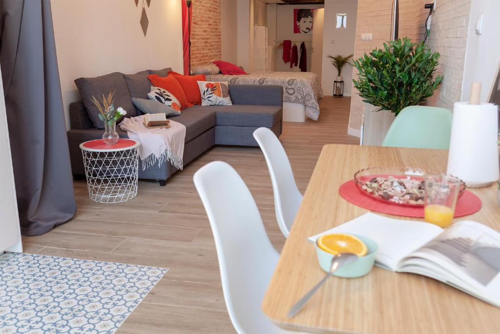 een woonkamer met een tafel en een bank bij B - NOGUERA APARTMENTS - ARTS AND SCIENCIES in Valencia