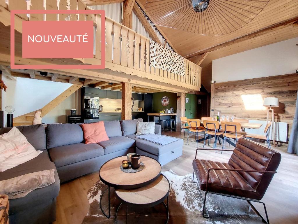 a living room with a couch and a table at Green Marmottes Chalet - 12 personnes - Pied des pistes - Saint Jean D Aulps in Saint-Jean-d'Aulps