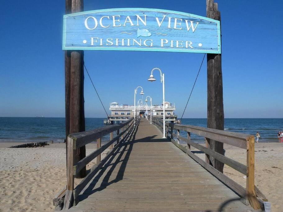 a sign for an ocean view fishing pier on a beach at CHEERFUL 5 BEDROOM HOUSE CENTREALLY LOCATED . in Norfolk